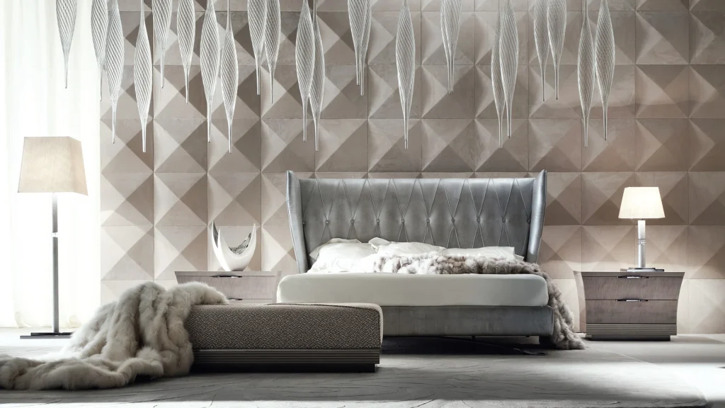 A grey upholstered bed with coordinated bedside tables and a bench.
